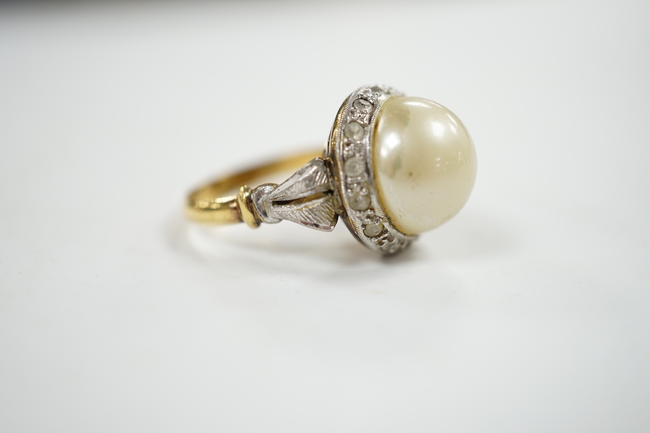 A yellow metal, simulated mabe pearl and paste set cluster ring, size O, gross weight 4.6 grams.